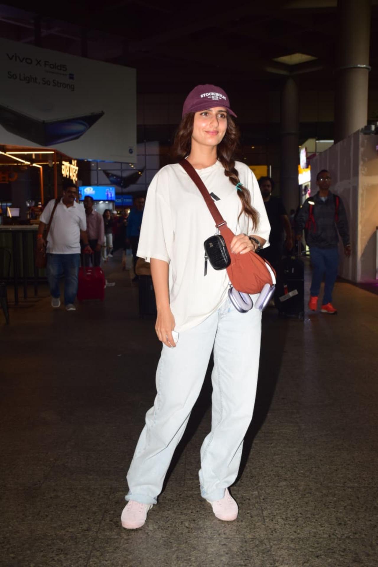 Fatima Sana Shaikh was spotted at the airport keeping her look casual yet chic. She wore a loose white oversized T-shirt paired with light blue baggy jeans.